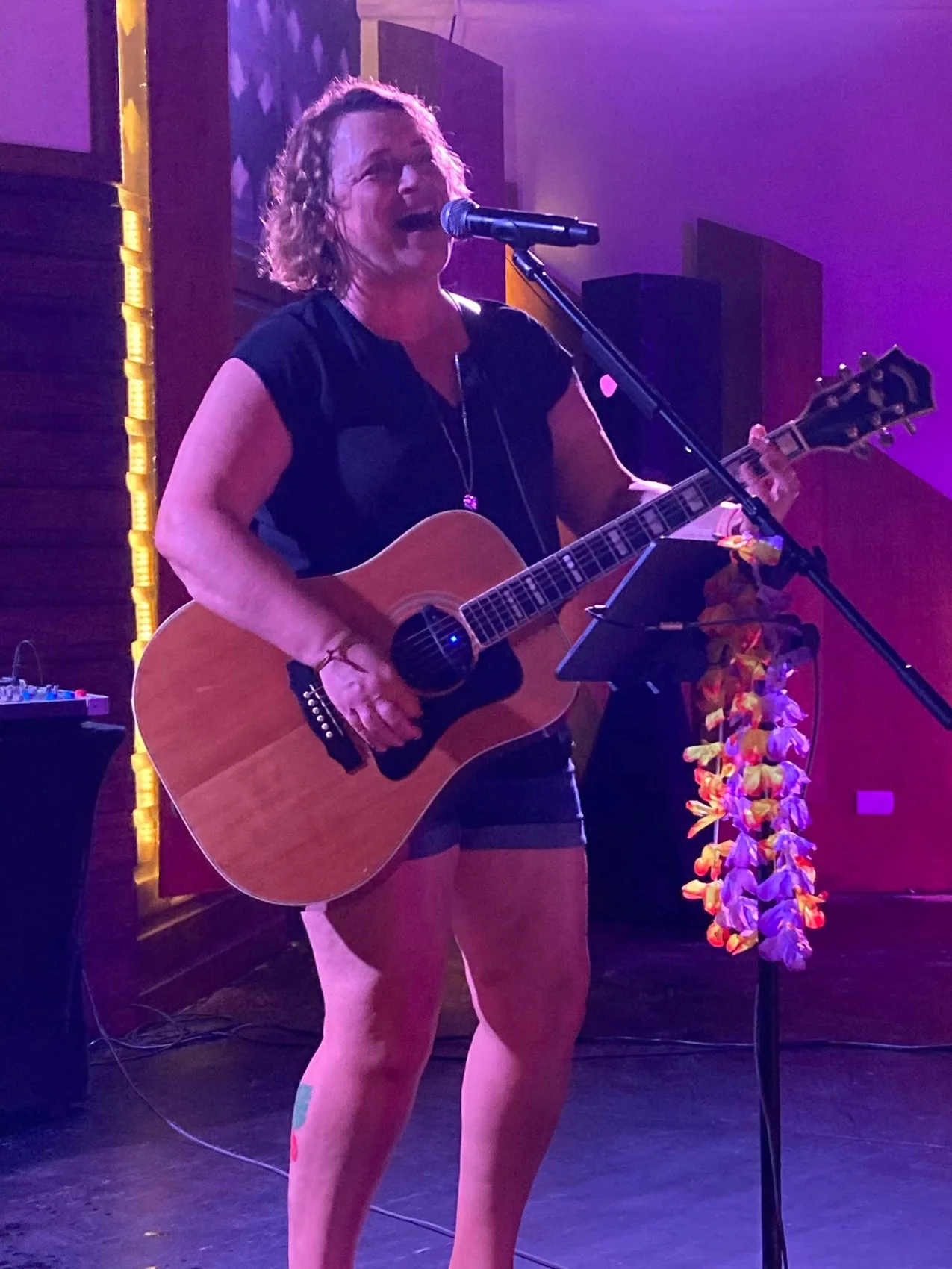 Lisa performing live with guitar